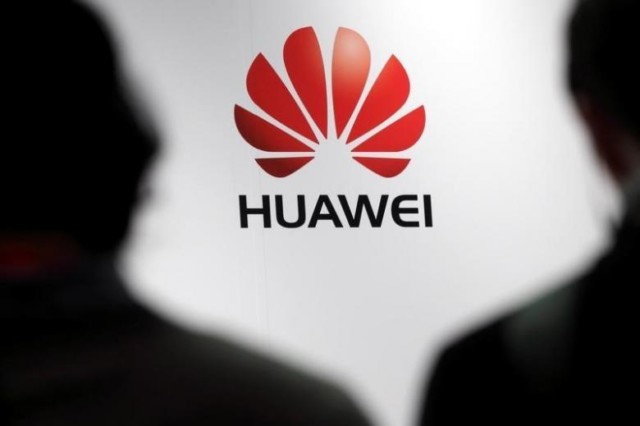 Journalists attend the presentation of the Huawei's new smartphone in Paris