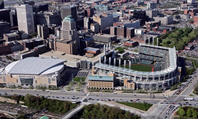 This May 20, 2005, file photo shows Jacobs Field (now Progressive Field), right, and Gund Arena (now Quicken Loans Arena) in Cleveland. When LeBron James and the Cavaliers, whose historic comeback in June against Golden State in the NBA Finals ended Cleveland’s title drought dating to 1964, receive their championship rings and a banner is raised in Quicken Loans Arena before their season opener, the emotional ceremony will merely be the warm-up act. (AP Photo/Mark Duncan, File)
