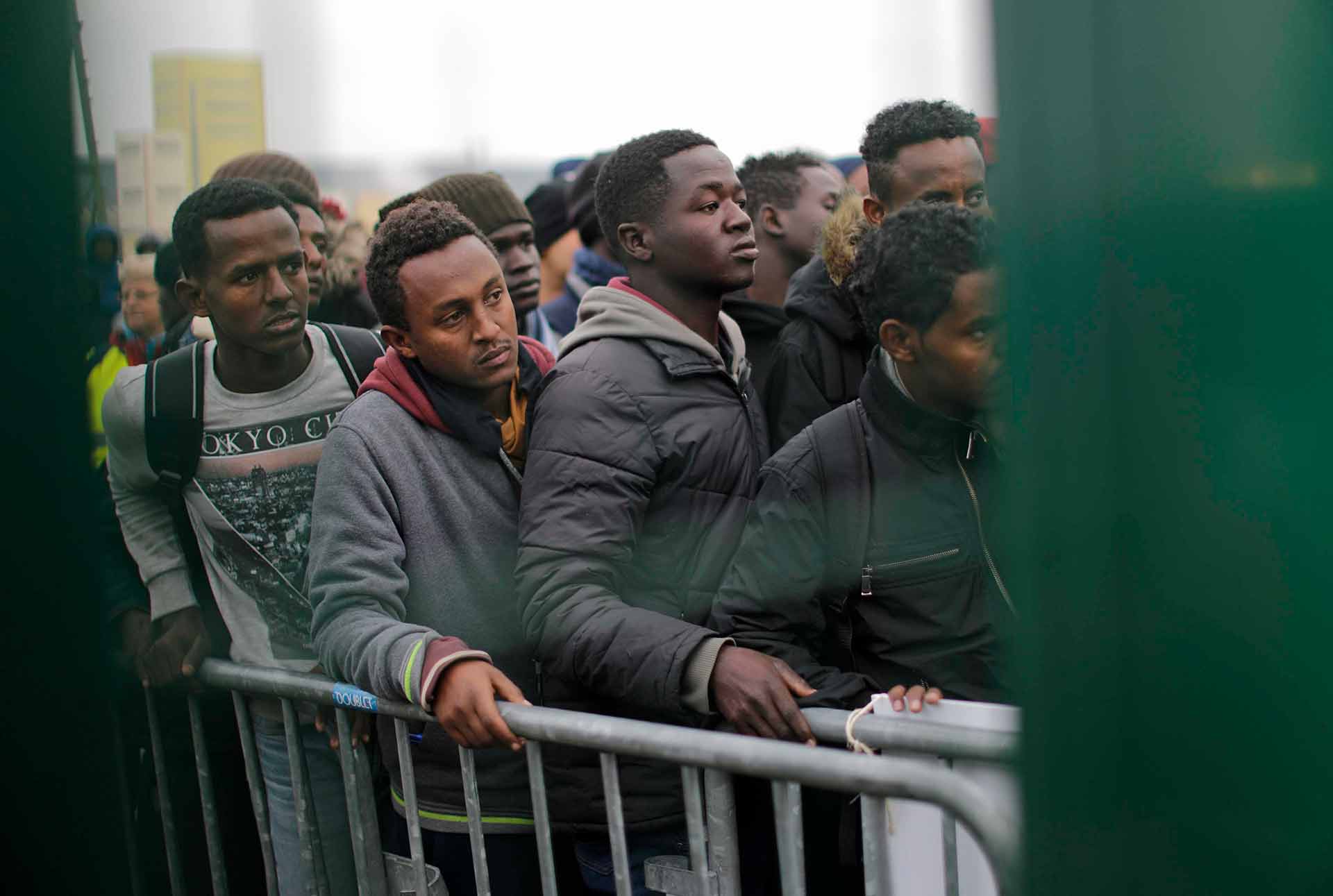 Migrants line-up to register at a processing centre in the makeshift migrant camp known as "the jungle" near Calais, northern France, Monday Oct. 24, 2016. (AP Photo/Emilio Morenatti)