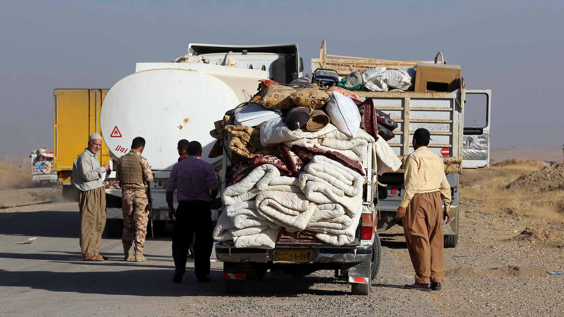 Iraqi displaced people, whose villages was liberated recently, return with their furniture and belongings, outside Mosul, Iraq, Thursday, Oct. 20, 2016. In a significant escalation of the battle for Mosul, elite Iraqi special forces joined the fight Thursday, unleashing a pre-dawn assault on an Islamic State-held town east of the besieged city. (AP Photo/ Khalid Mohammed)
