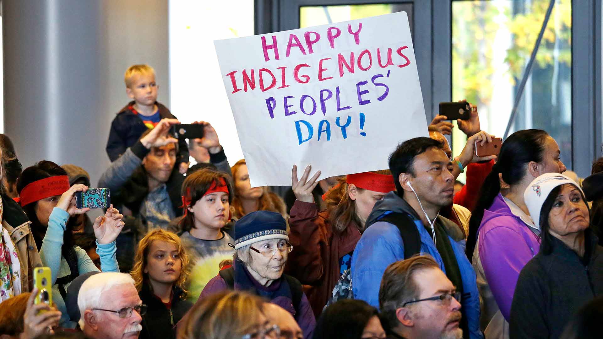 People look on at a celebration of Indigenous Peoples’ Day Monday, Oct. 10, 2016, at Seattle's City Hall. Seattle began observing Indigenous Peoples’ Day in 2014 to promote the well-being and growth of Seattle’s American Indian and Indigenous community. (AP Photo/Elaine Thompson)