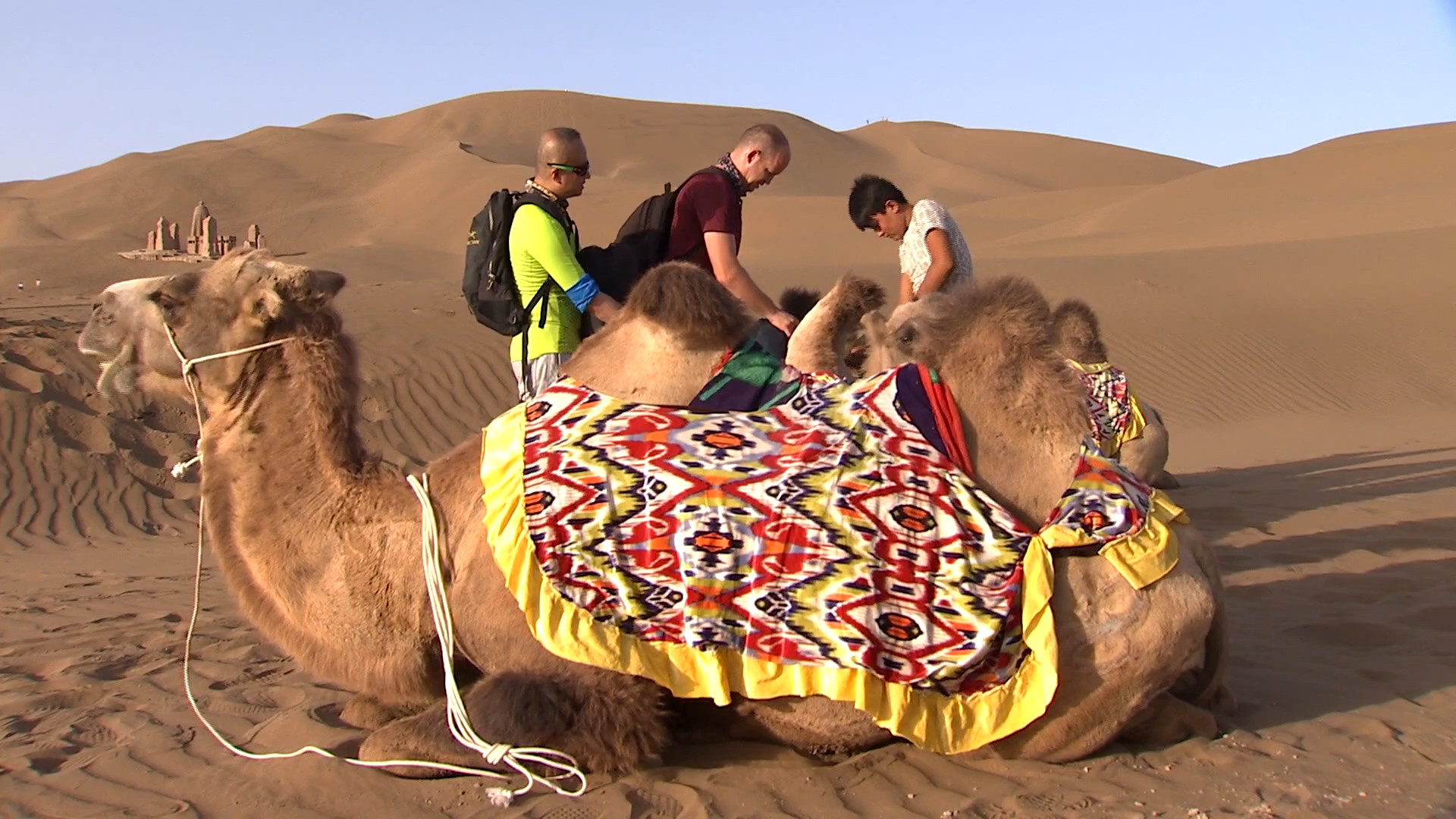 Josh Summers and Han Bin go on a camel expedition in the desert outside of Kashgar.