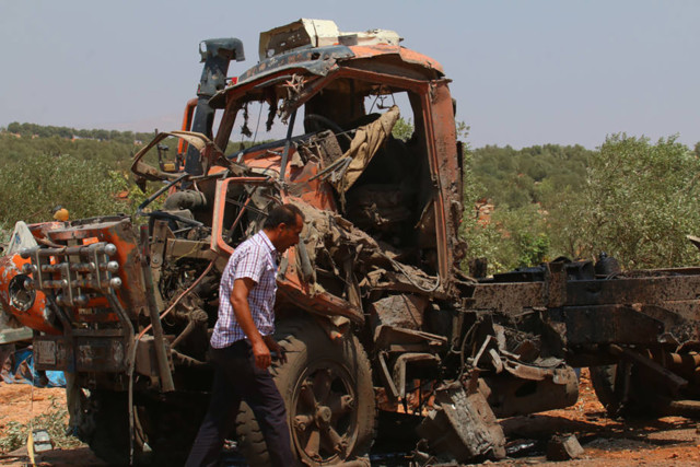 Syrian man with broken tractor