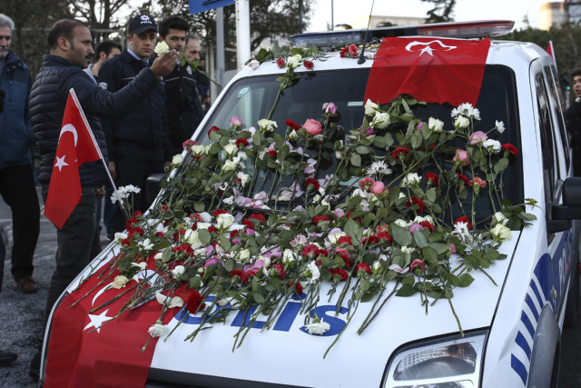 carnations and roses on a police car