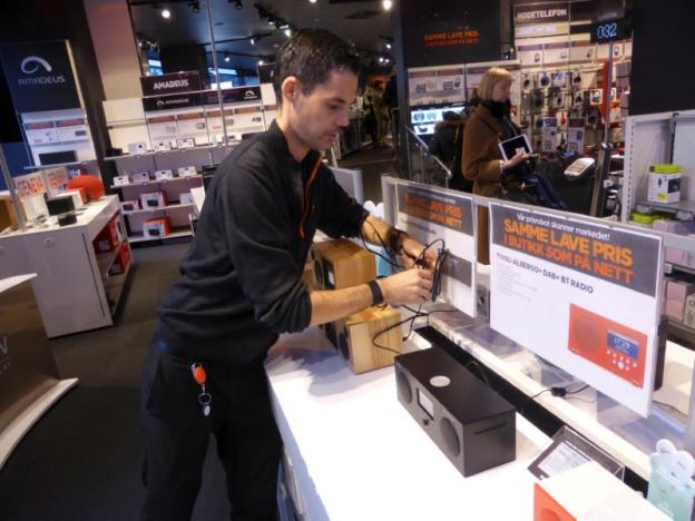 Worker Nilsen arranges digital radios in an Expert City electronics shop in Oslo