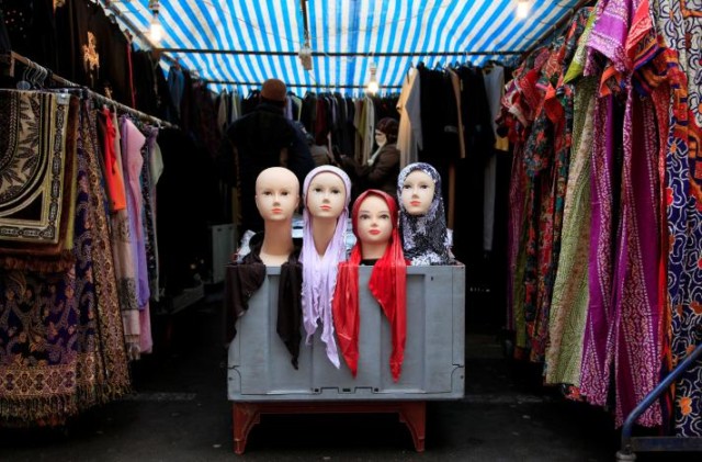FILE PHOTO: People look at a market stall selling the hijab in east London