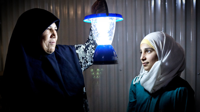 Al Azraq residents with solar lamps