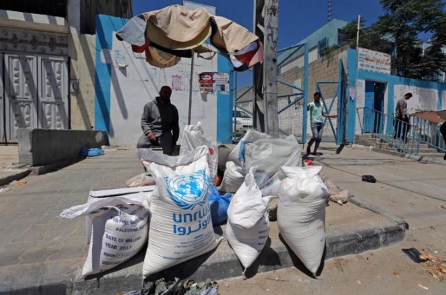 A Palestinian man sits outside the United Nations food distribution center in Khan Younis in the southern Gaza Strip
