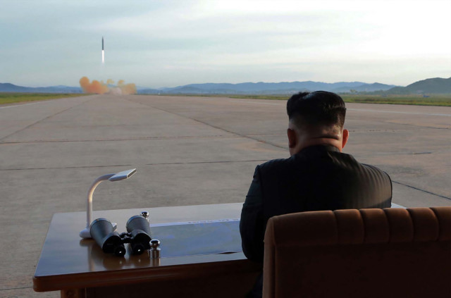 This undated picture released from North Korea's official Korean Central News Agency (KCNA) on September 16, 2017 shows North Korean leader Kim Jong-Un inspecting a launching drill of the medium-and-long range strategic ballistic rocket Hwasong-12 at an undisclosed location. (AFP PHOTO / KCNA VIA KNS)
