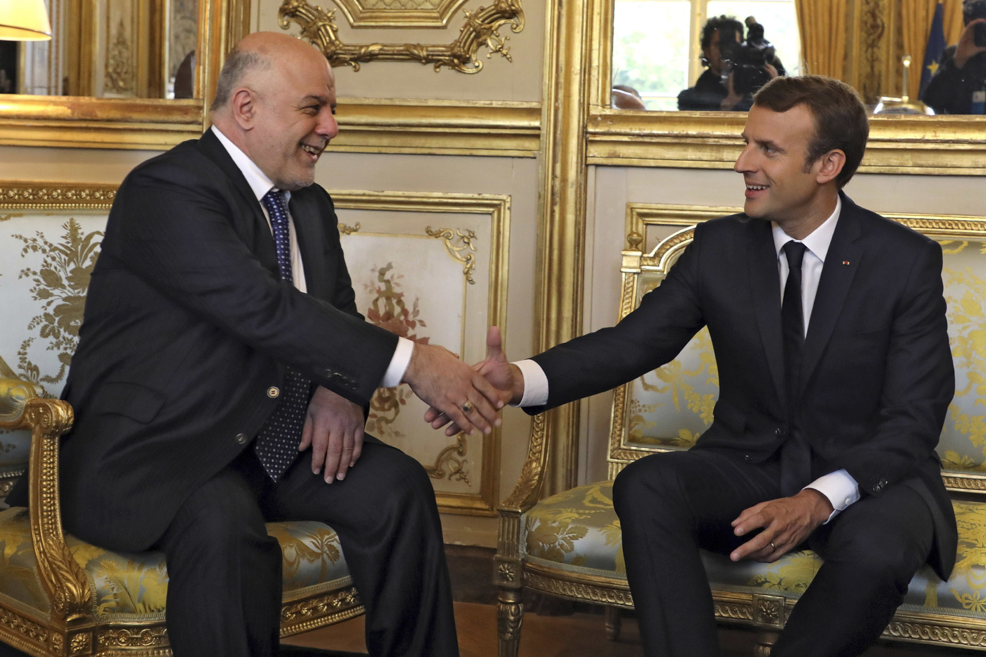 French president Emmanuel Macron shakes hands with Iraqi Prime minister Haider al-Abadi