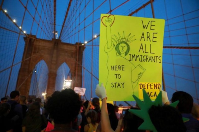 People march across the Brooklyn Bridge to protest the planned dissolution of DACA in Manhattan, New York City, U.S.
