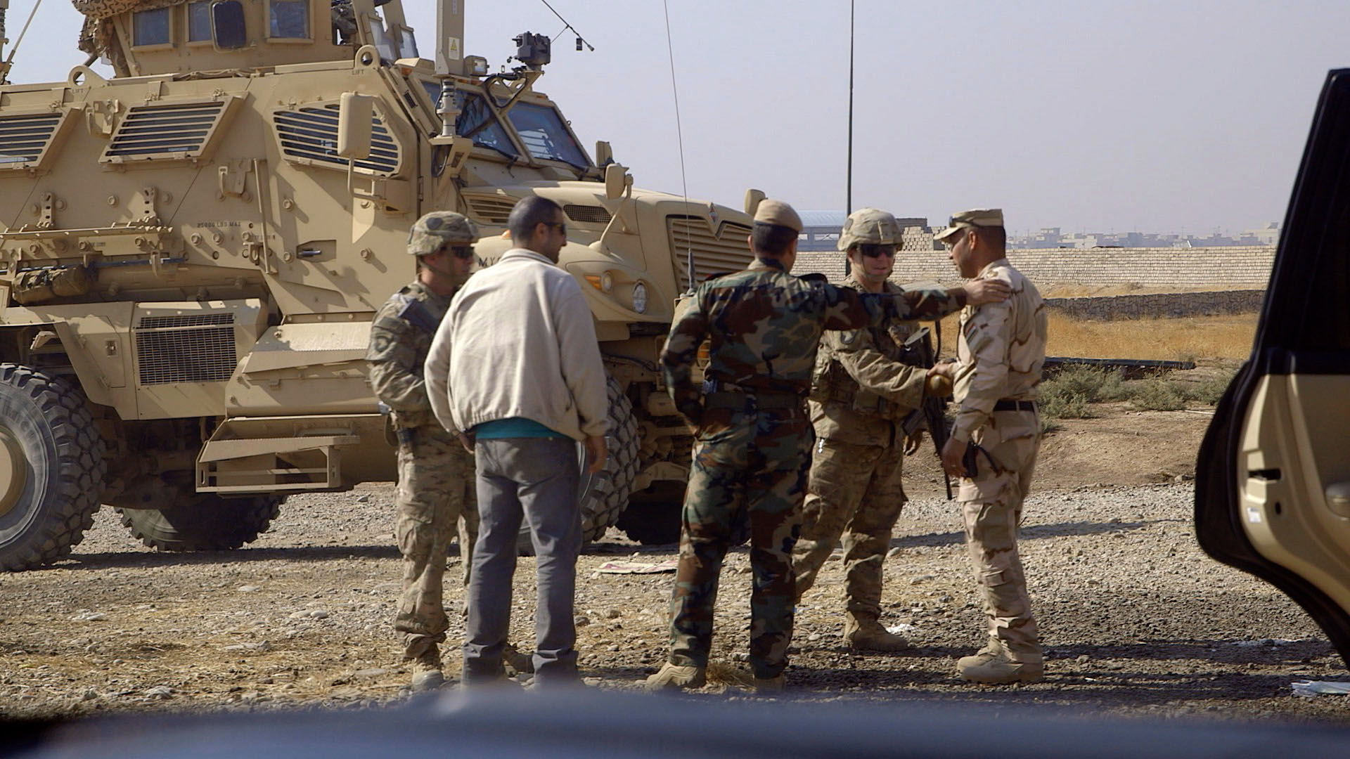 In Bartella, a Peshmerga general meets the international coalition’s U.S. advisors.