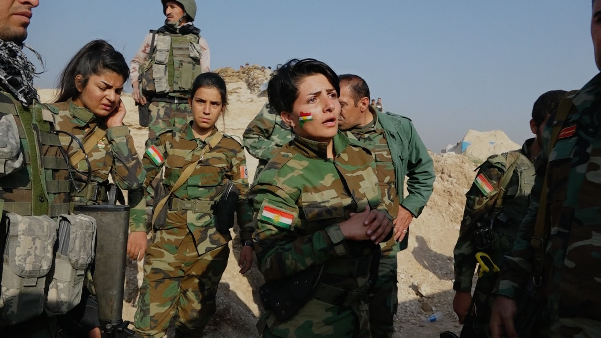 An Iraqi soldier awaits news of her injured comrade.  