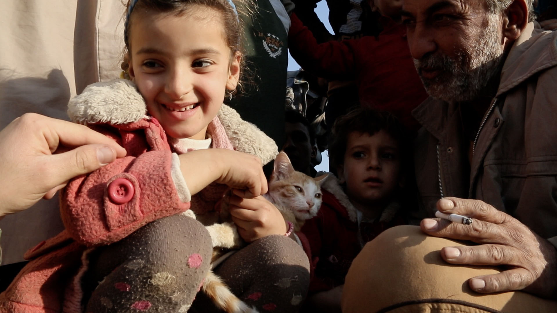 A young girl at the entrance of Camp Khazar shares her hope for a future without the Islamic State. 