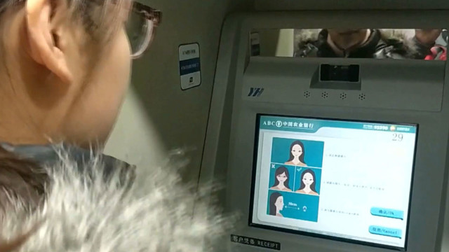 Bank customers in China put best face forward to get money from ATMs
