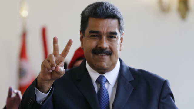 Venezuela's President Nicolas Maduro makes the victory sign