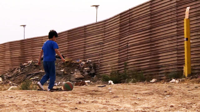 BORDER WALL - young boy playing soccer