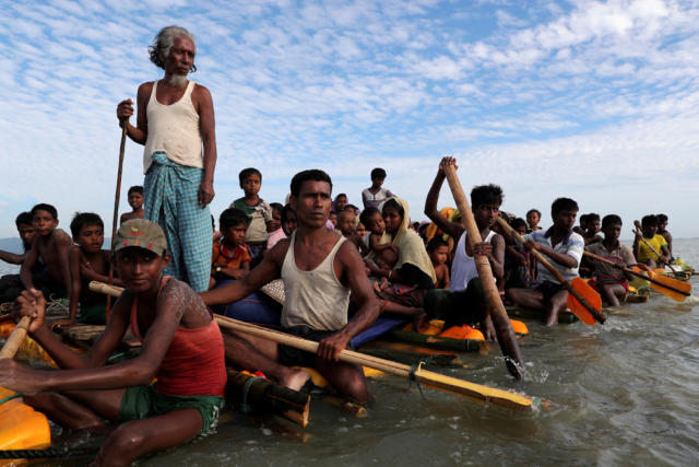 FILE PHOTO: Rohingya refugees cross the Naf River with an improvised raft to reach to Bangladesh in Teknaf