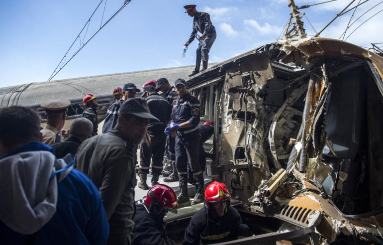 civil defence are seen at the scene of a rail accident