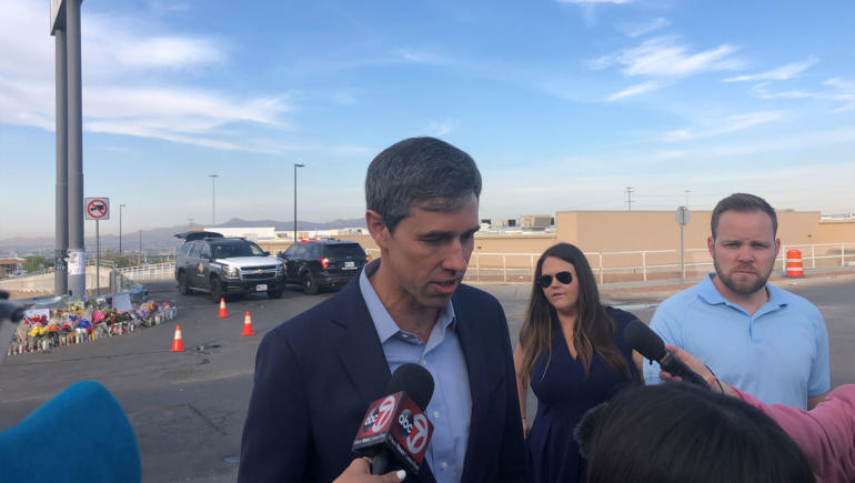 Beto O’Rourke speaks to reporters near the makeshift memorial in El Paso.