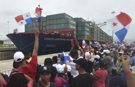 A giant Chinese-chartered freighter nudged its way into the expanded Panama Canal