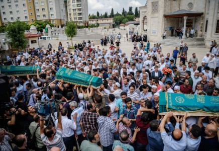 Crowd carrying the coffins of the victims