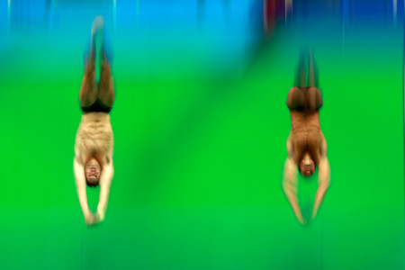 two men diving into pool