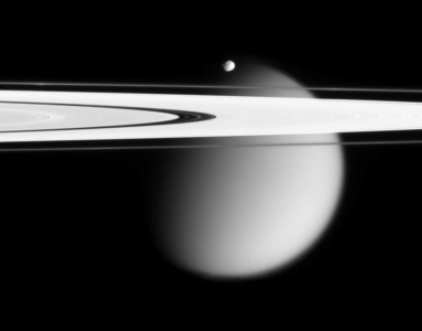 This image shows the small, battered Epimetheus and smog-enshrouded Titan, with Saturn's A and F rings stretching across the scene. (AP Photo/NASA) Saturns Epimetheus and Titan moons
