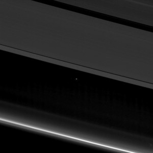 Planet Earth and the moon, left, as small points of light behind the rings of Saturn, captured by the Cassini spacecraft, 870 million miles (1.4 billion kilometers) away from Earth. A view of Earth from Saturn