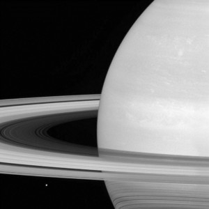 Saturn's icy moon Mimas is dwarfed by the planet's enormous rings. Consider it a cosmic carousel with countless rings up for grabs. (NASA/JPL-Caltech/Space Science Institute via AP)