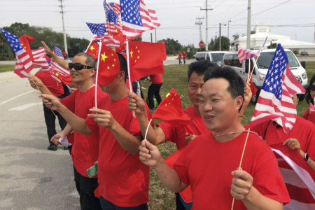 Supporters of Chinese President Xi Jinping line the street outside Palm Beach International Airport in West Palm Beach, Fla., Thursday April 6, 2017. (AP Photo/Lynne Sladky) XI Supporters