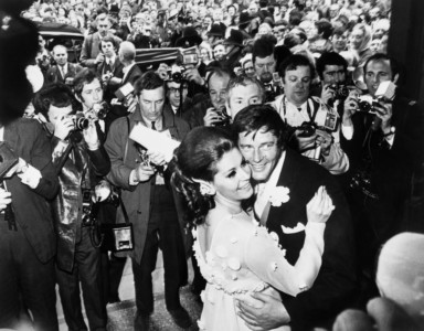 British actor Roger Moore and his new wife Italian actress Luisa Mattioli, are surrounded by the press as they dance at Caxton Hall in London following their wedding on April 12, 1969. (PHOTO: AFP PHOTO / STRINGER) Roger Moore