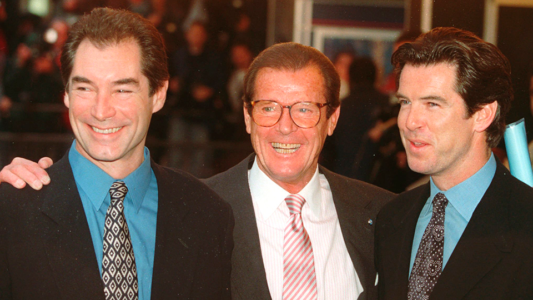 Three of the actors who played James Bond, Timothy Dalton, left, Roger Moore, center, and Pierce Brosnan, present at a London cinema to celebrate the life of Albert R. "Cubby" Broccoli, the American film producer behind 17 Bond movies on Sunday, Nov. 17, 1996. In total, six actors have portrayed Bond officially. (PHOTO: AP Photo/Alastair Grant) Roger Moore