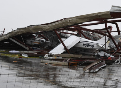 Badly damaged light planes in their hanger at Rockport Airport after heavy damage when Hurricane Harvey hit Rockport, Texas on August 26, 2017.
Hurricane Harvey left a trail of devastation Saturday after the most powerful storm to hit the US mainland in over a decade slammed into Texas, destroying homes, severing power supplies and forcing tens of thousands of residents to flee. / AFP PHOTO / Mark RALSTON Hurricane Harvey Slams Into Texas Gulf Coast