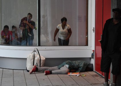 A man sleeps outside the Convention Center which is housing evacuees from flooded homes after Hurricane Harvey caused heavy flooding in Houston, Texas on August 29, 2017.
(AFP PHOTO / MARK RALSTON)