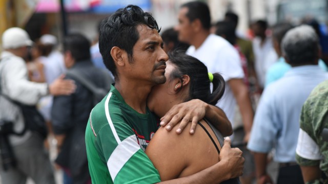 A couple embraces on September 8, 2017 in Juchitan de Zaragoza, state of Oaxaca, where buildings collapsed after an 8.2 earthquake that hit Mexico's Pacific coast.
(AFP PHOTO / Pedro PARDO)