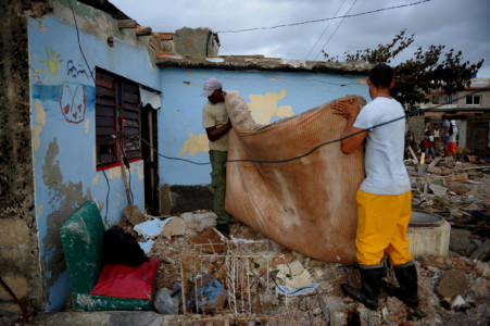 Cubans recover their belongings after the passage of Hurricane Irma, in Cojimar neighborhood in Havana, on September 10, 2017. (AFP PHOTO / YAMIL LAGE)