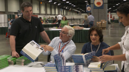 Roberto and Lauri Canessa signing books