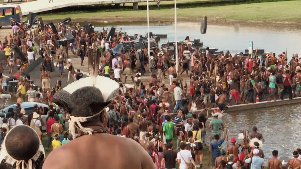 In front of Brazil’s congress, Amazonian natives throw fake coffins into the water, in a protest of their struggle to survive. Protest at Brazil’s congress
