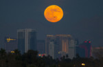 The first supermoon of the new year rises above the Vegas Strip on Monday, Jan. 1, 2018. (Richard Brian/Las Vegas Review-Journal via AP)