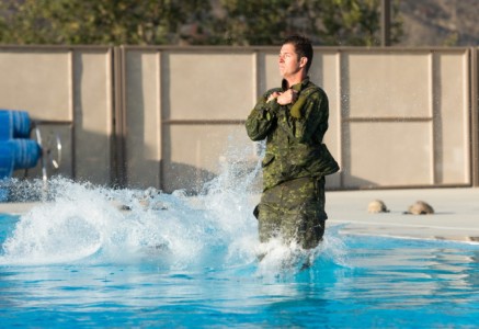 Corporal Luke Butts of the Canadian 2nd Battalion Royal 22e Régiment Recon team jumps into the water for the Marine Force Recon swim test during the biennial Rim of the Pacific (RIMPAC) exercise at Marine Corps Base Camp Pendleton, July 6. (Canadian Armed Forces Photo by Ordinary Seaman Justin Spinello/Released) Recon and Sniper Team Swim Test RIMPAC 2018