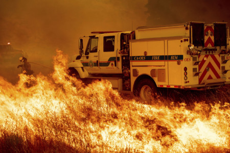 Water truck at site of the Pawnee fire that spots across Highway 20 near Clearlake Oaks, Calif., on Sunday, July 1, 2018. (AP Photo/Noah Berger) Water truck putting out fire