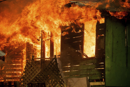 A structure burns as the Carr Fire tears through Shasta, Calif., Thursday, July 26, 2018. Fueled by high temperatures, wind and low humidity, the blaze destroyed multiple homes and at least one historic building. (AP Photo/Noah Berger) Burning house