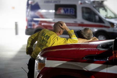 Marin County firefighters wait outside the Mercy Medical Center emergency room as an injured crew member receives treatment on Thursday, July 26, 2018, in Redding, Calif. (AP Photo/Noah Berger) Firefighters waiting