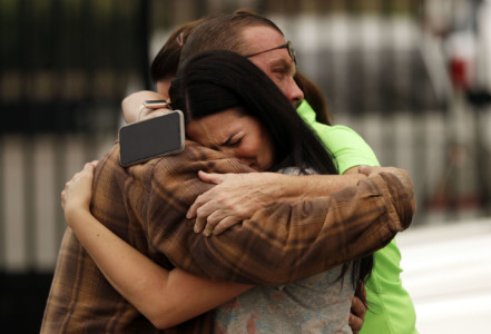 Friends of the Bledsoe family embrace outside of the sheriff's office in Redding, Calif., on Saturday, July 28, 2018, after hearing news of the death of Melody Bledsoe and her great-grandchildren James Roberts, 5, and Emily Roberts, 4, who were killed at their home by an advancing wildfire. (AP Photo/Marcio Jose Sanchez) People embracing and crying