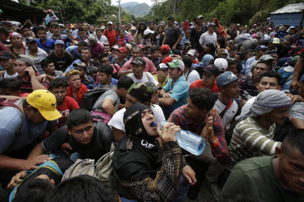 Hundreds of Hondurans are blocked at the border crossing in Agua Caliente, Guatemala, Monday, Oct. 15, 2018. A caravan of Honduran migrant moved towards the country's border with Guatemala in a desperate attempt to flee poverty and seek new lives in the United States. (AP Photo/Moises Castillo) Hundreds of Hondurans are blocked at the border crossing in Agua Caliente, Guatemala