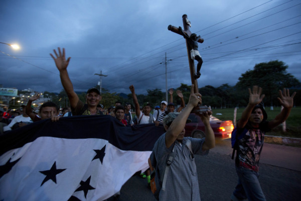 A Honduran migrant holds up a replica of the Black Christ of Esquipulas as a caravan of migrants making their way to the U.S. arrives to Esquipulas, Guatemala, Monday, Oct. 15, 2018. (AP Photo/Moises Castillo) Honduran migrant holds up a replica of the Black Christ of Esquipulas