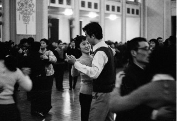 A photo in Beijing 1978 shows young people dancing at a ball hosted in the Great Hall of the People. (Source: Li Xiaobin’s: “Revolutions in China” via VCG)