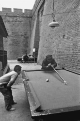 A photo in Xian in 1996 shows a little boy playing pool with his grandfather. (Source: Hu Gongyong’s :“The stories of the Sifang City” via VCG)