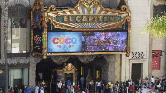 This Nov. 22, 2017 photo shows crowds lining up at the El Capitan Theatre for a screening of the Disney Pixar film "Coco" in Los Angeles. The film, a contender for an Oscar for best animated feature, is the latest from Pixar, the animation studio co-founded by John Lassater. He’s currently on a “sabbatical” following his admission of inappropriate behavior. (AP Photo/Chris Pizzello)